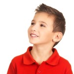 Pretty young happy boy looking away